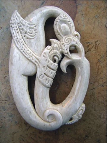 A whalebone carving that depicts Tangaroa inspecting a matau, or fish hook
