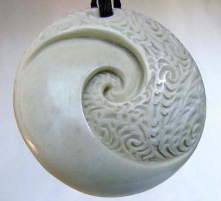 In this double spiral carving, the two ira are expressed as the plain and the textured elements