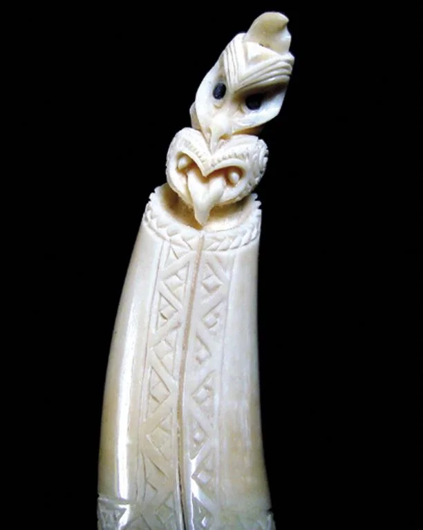 The subject of this whale tooth carving is Rehua, the summer star Antares, wrapped in a korowai cloak. The korowai and the heru in his hair are ways of showing his status among the stars. The carving was done as a stopper for the end of a rehu, or l…