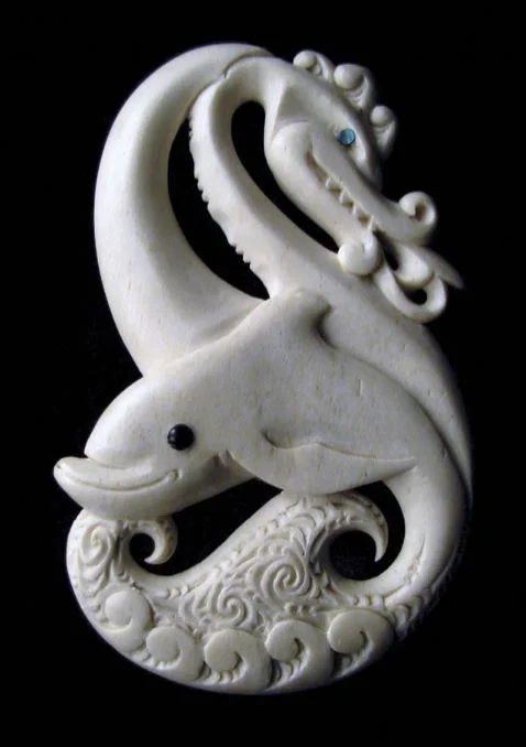 One of a pair of carvings which blend the dual ancestry of a local family, whose Māori traditions are linked to a guardian dolphin and whose Welsh traditions are associated with a dragon.