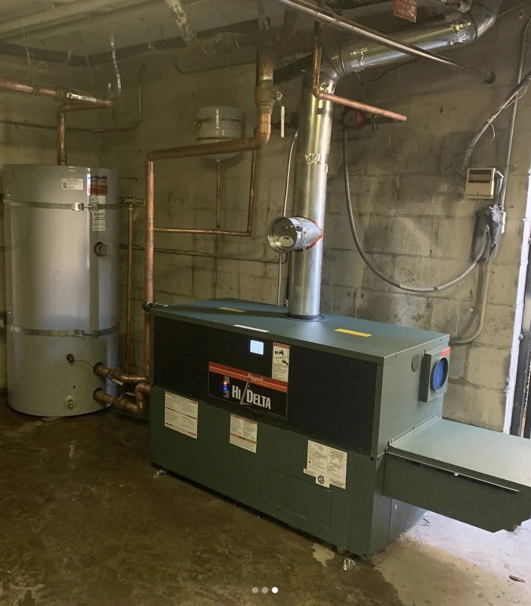 Raypak Hi-Delta commercial boiler installation with 119-gallon American storage tank at a Los Angeles apartment complex, installed by licensed local plumbing contractor.