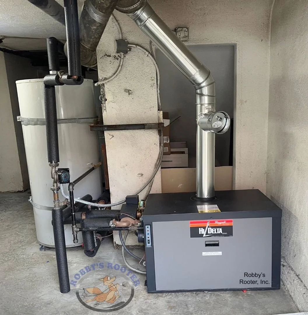 Raypak Hi-Delta commercial boiler installation with two 119-gallon storage tanks at a Hollywood Los Angeles apartment complex, installed by licensed local plumbing contractor.