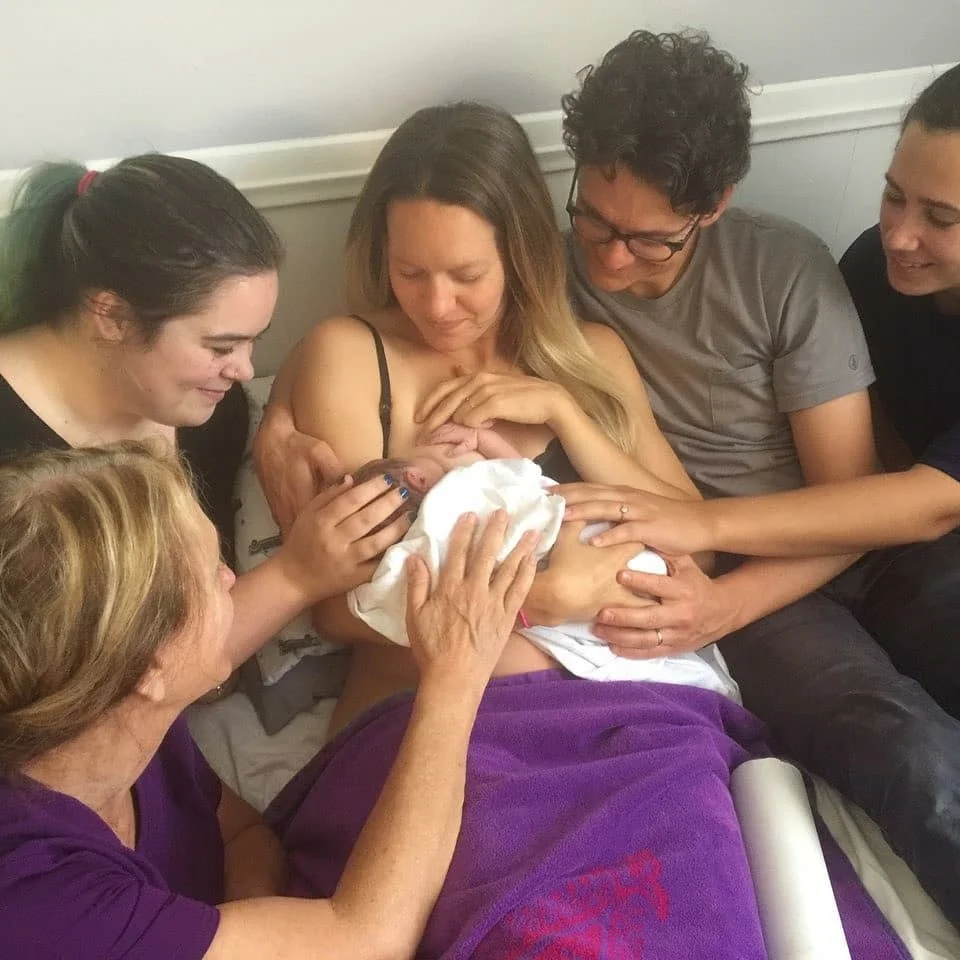 With Paula's Midwifery, birth is a family affair. Here, Paula and Haley are soaking up this precious moment after assisting a home birth.