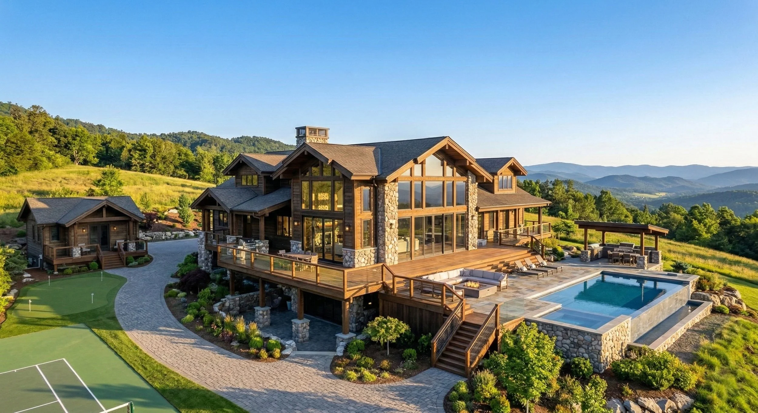 A large mountain home with a wooden exterior, stone accents, and expansive windows, featuring a deck, a swimming pool, a small balcony, and a lush landscape with mountains in the background.