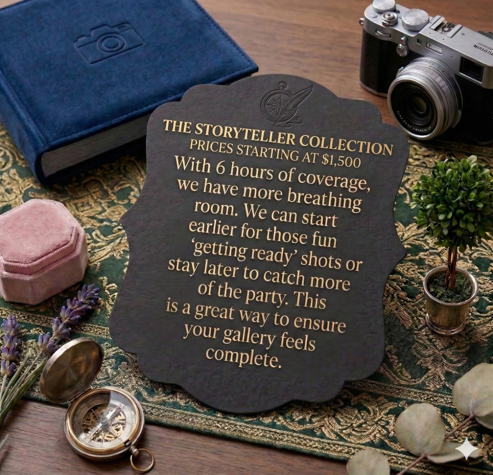 A vintage camera, a blue notebook, a black sign with gold text about a storytelling collection, a pair of cufflinks, a pocket watch, and some small plants arranged on a decorative cloth.