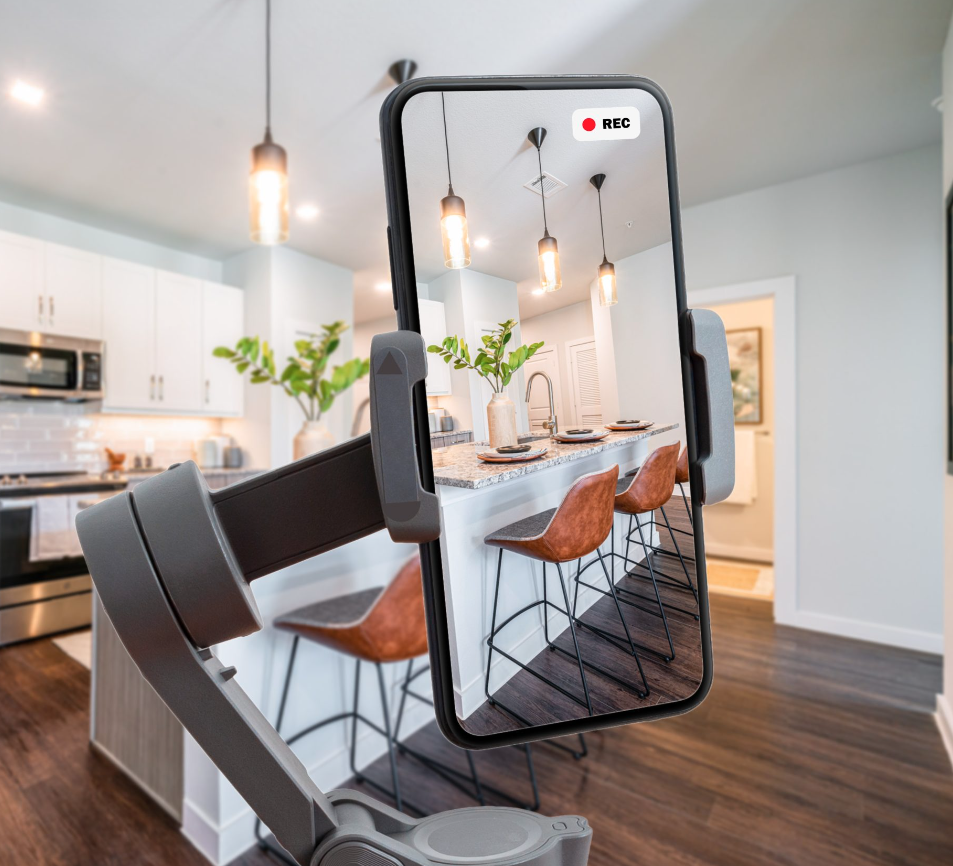Smartphone on stabilizer recording modern kitchen with counter and bar stools.