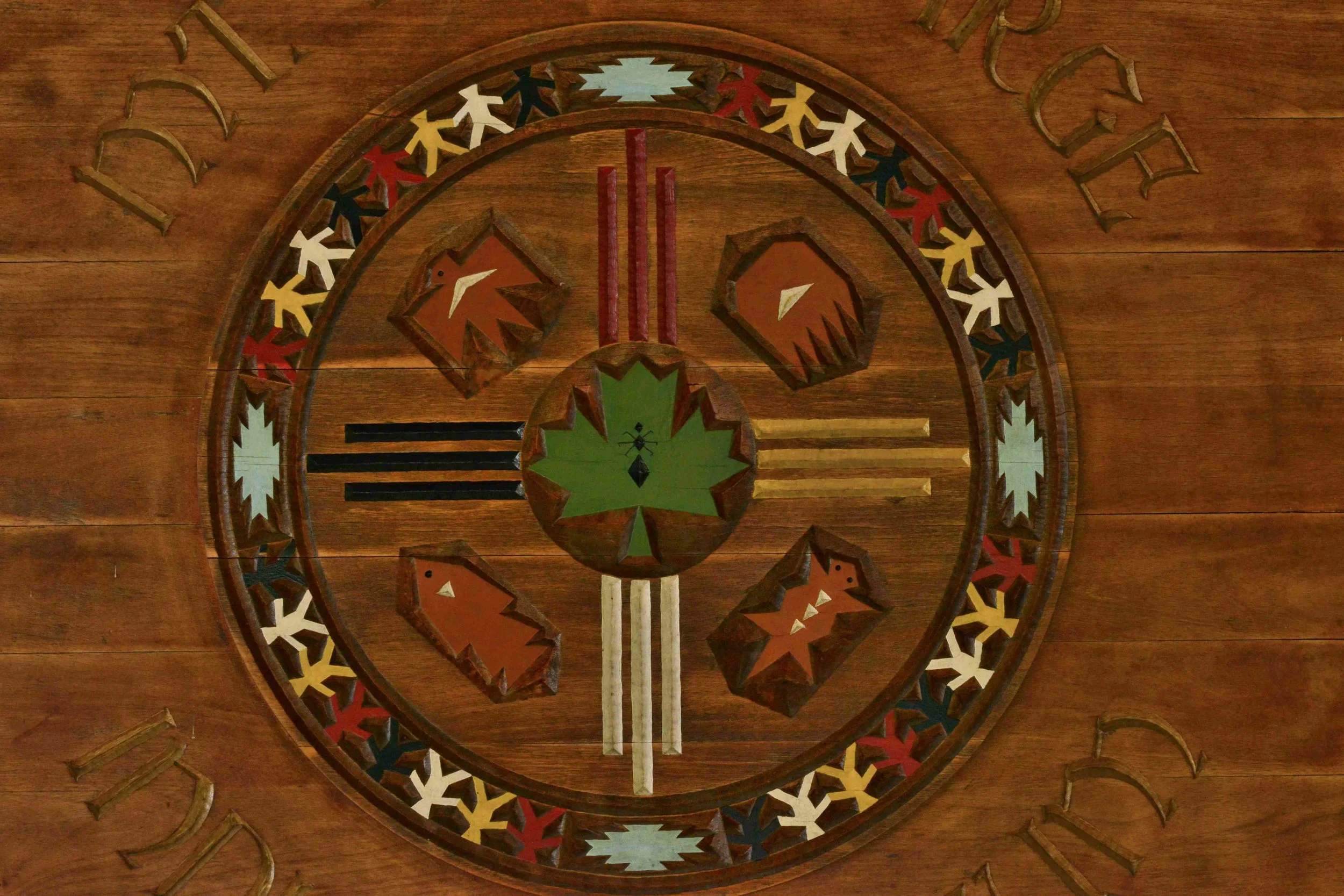 Painted Native-inspired wood artwork representing museum membership at Mt. Kearsarge Indian Museum in New Hampshire