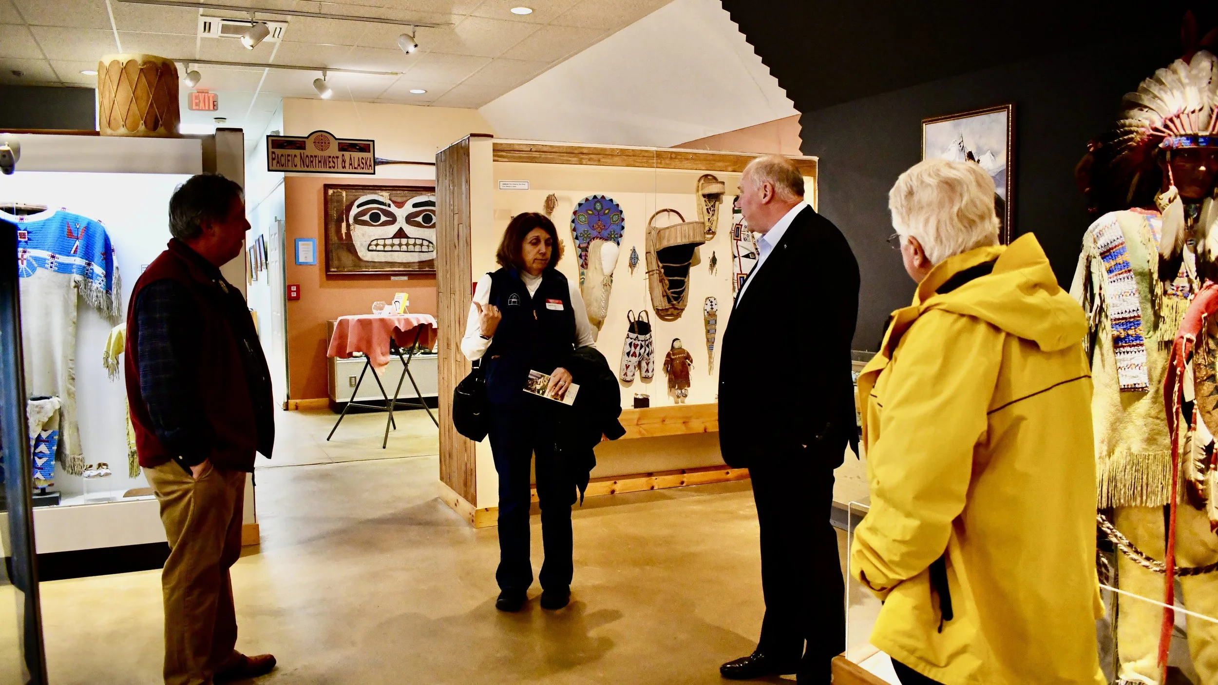 Tour group viewing cultural artifacts in a museum exhibit