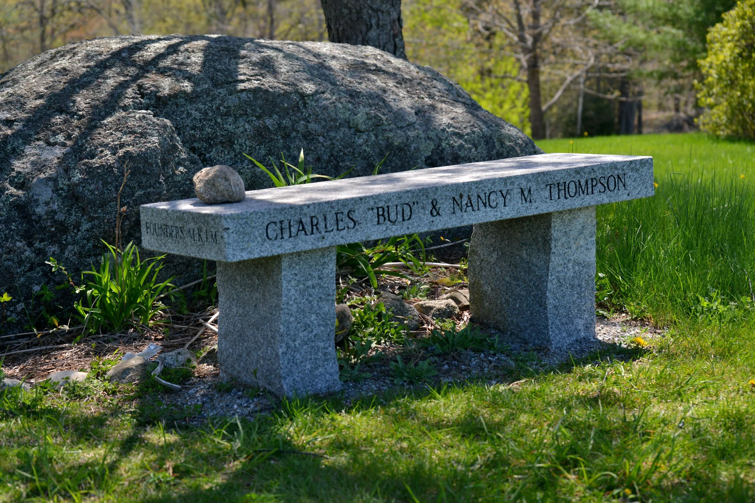 Stone memorial bench with engraved names at Mt. Kearsarge Indian Museum representing legacy giving and donor support