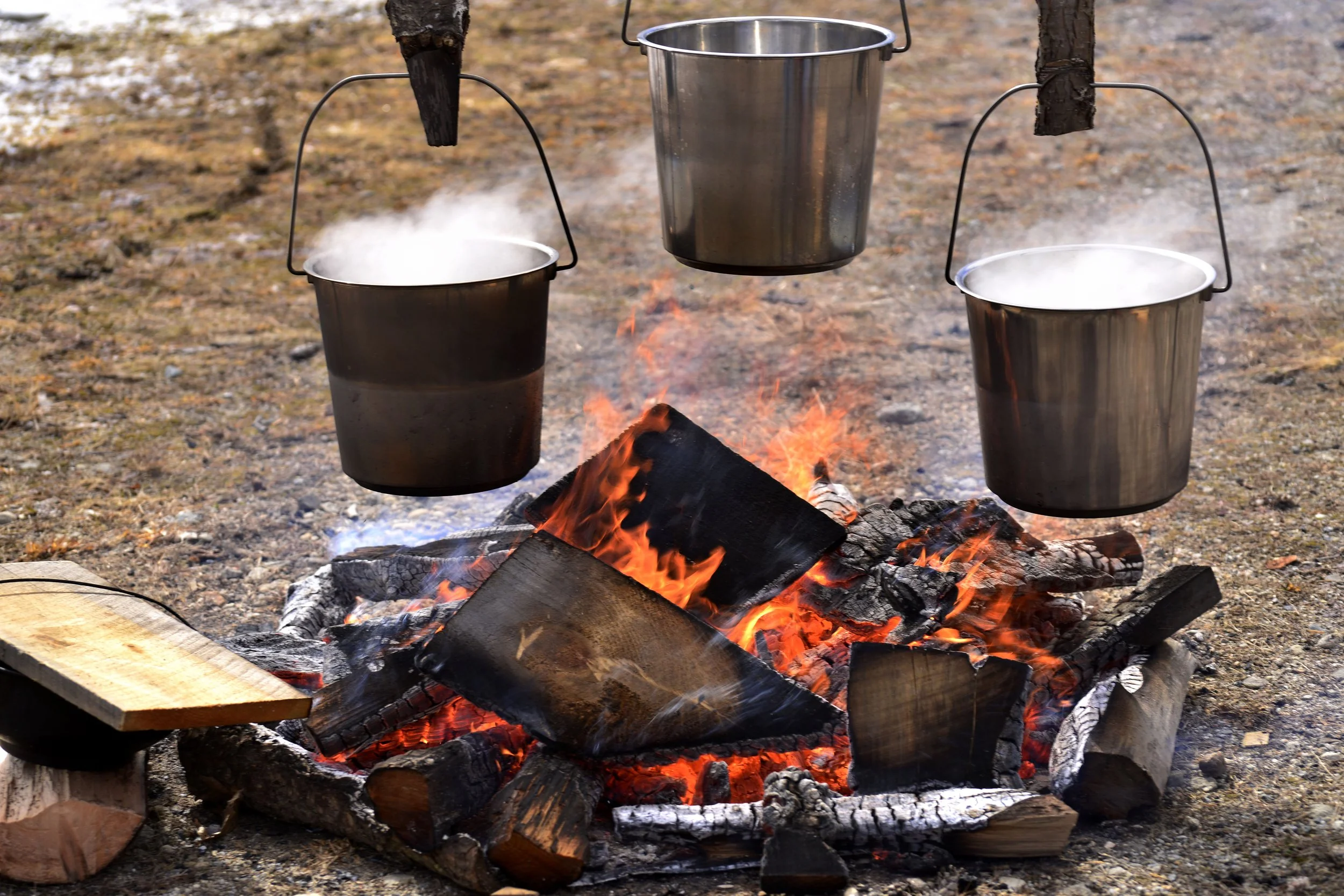 Traditional maple sugar making demonstration over an outdoor fire