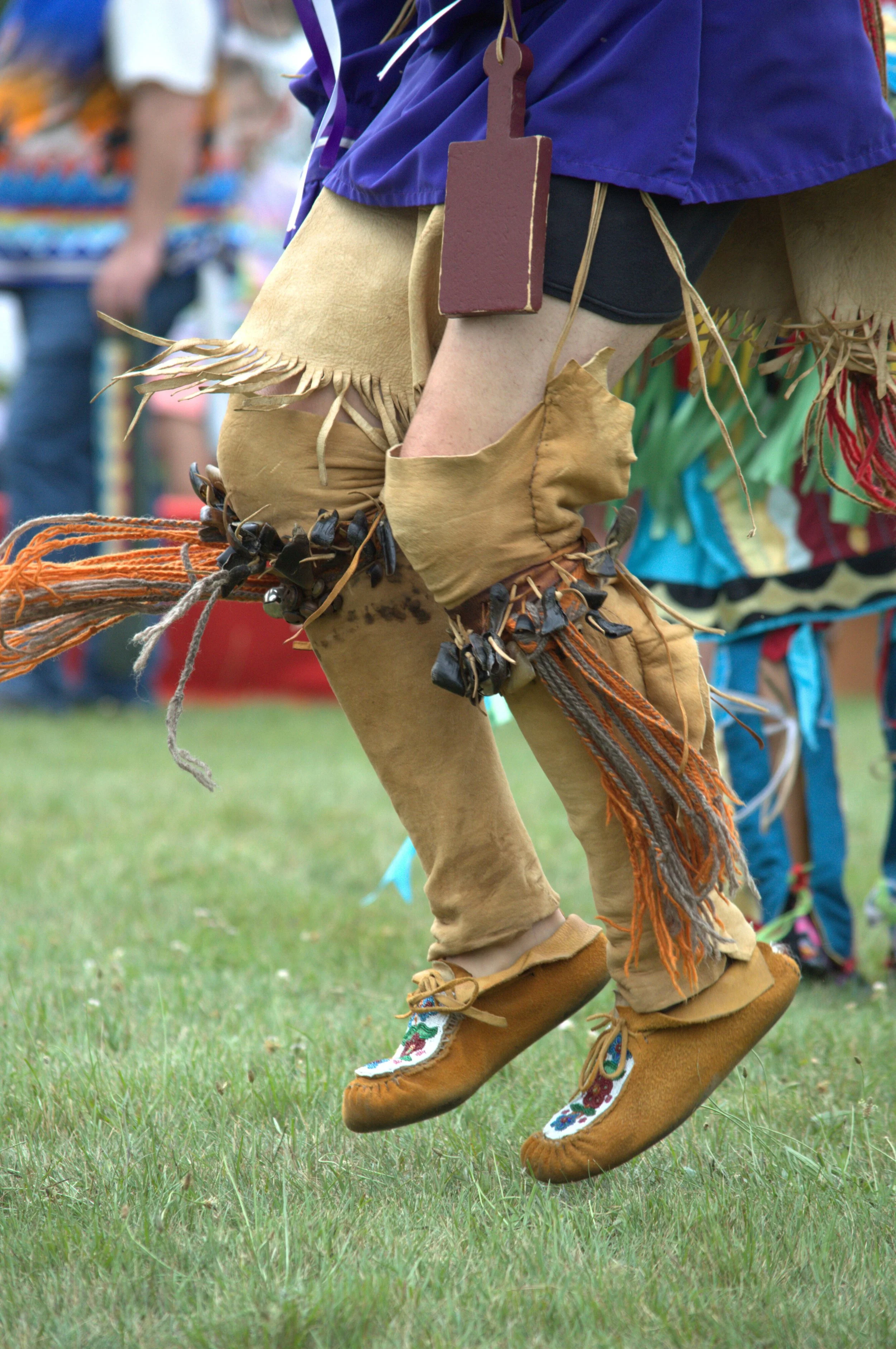 Female powwow dancer performing in traditional regalia during a cultural celebration