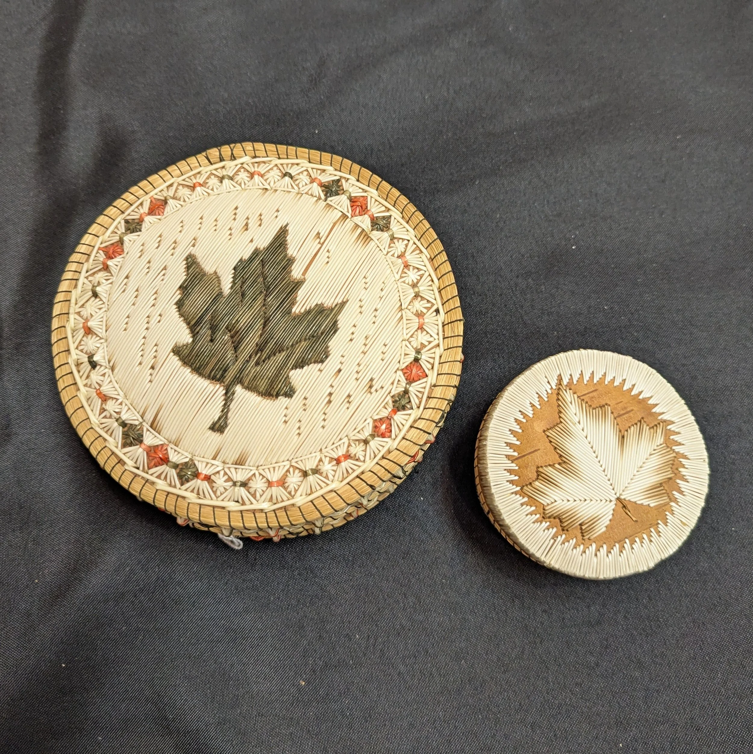 Two quilled maple leaf boxes, links to donation page