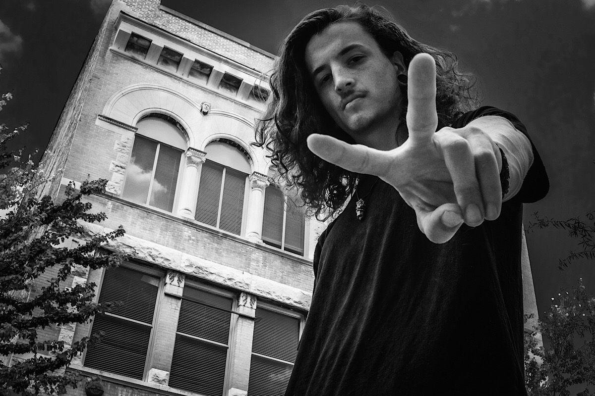 Another one of my favorites. I was sitting down on the sidewalk, aiming almost straight up at Alex. The pose was his. I really like the way his face is perfectly framed in his victory sign and the details on the building in the background. I applied an HDR effect to this image during editing. (Click on photo to enlarge)