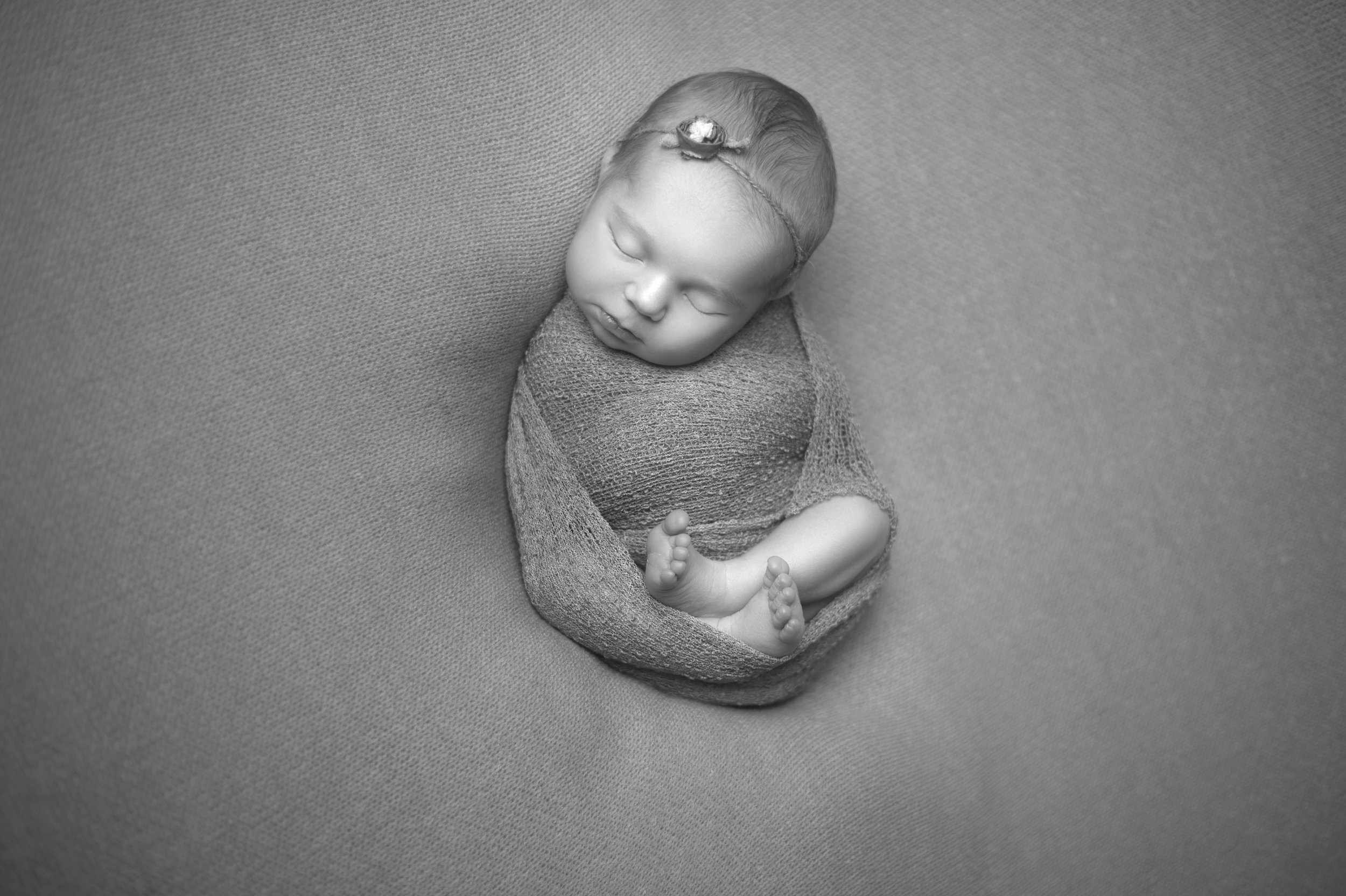 ewborn baby wrapped in a personalized blanket