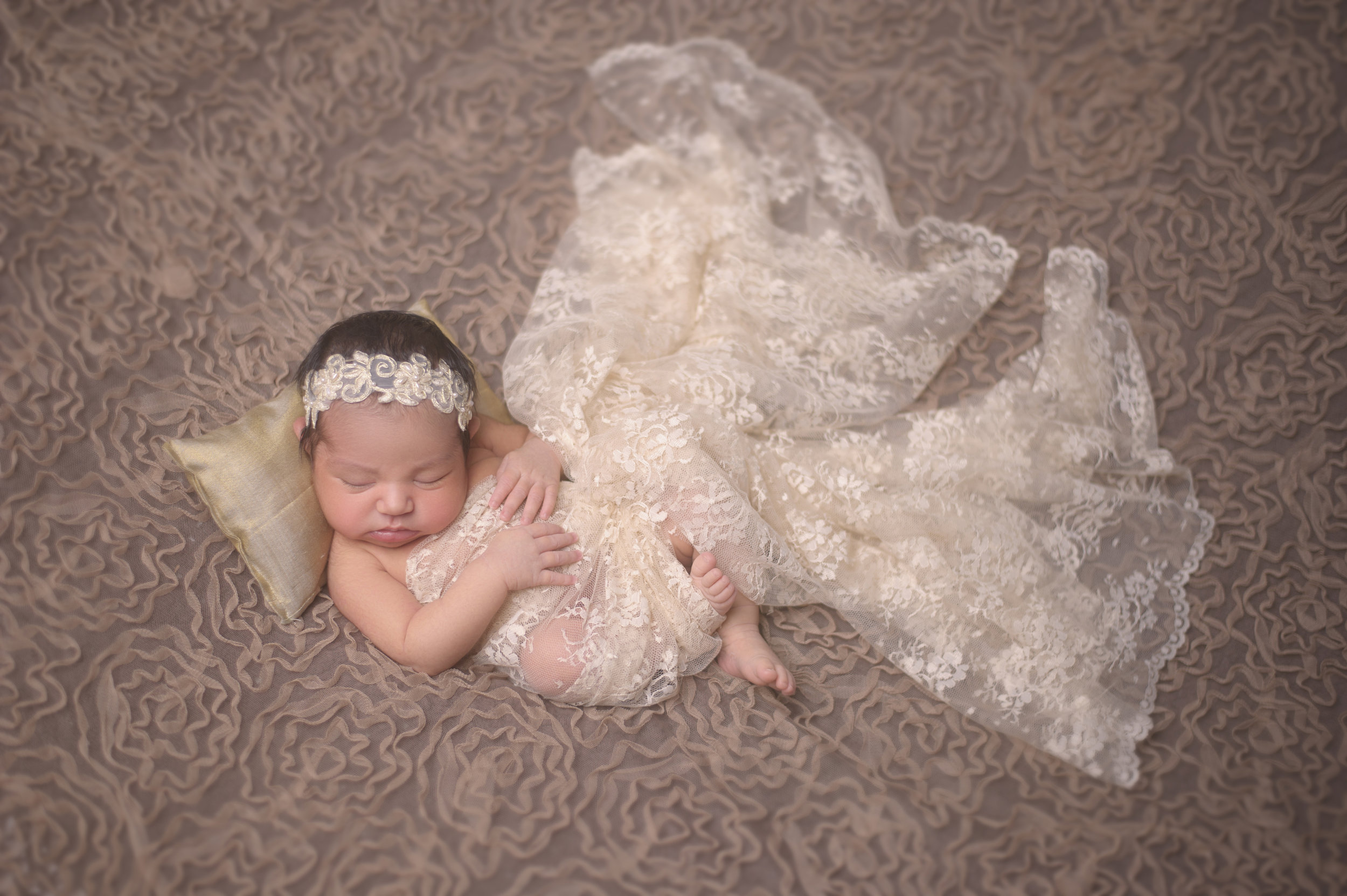 Newborn baby posed in a cute outfit