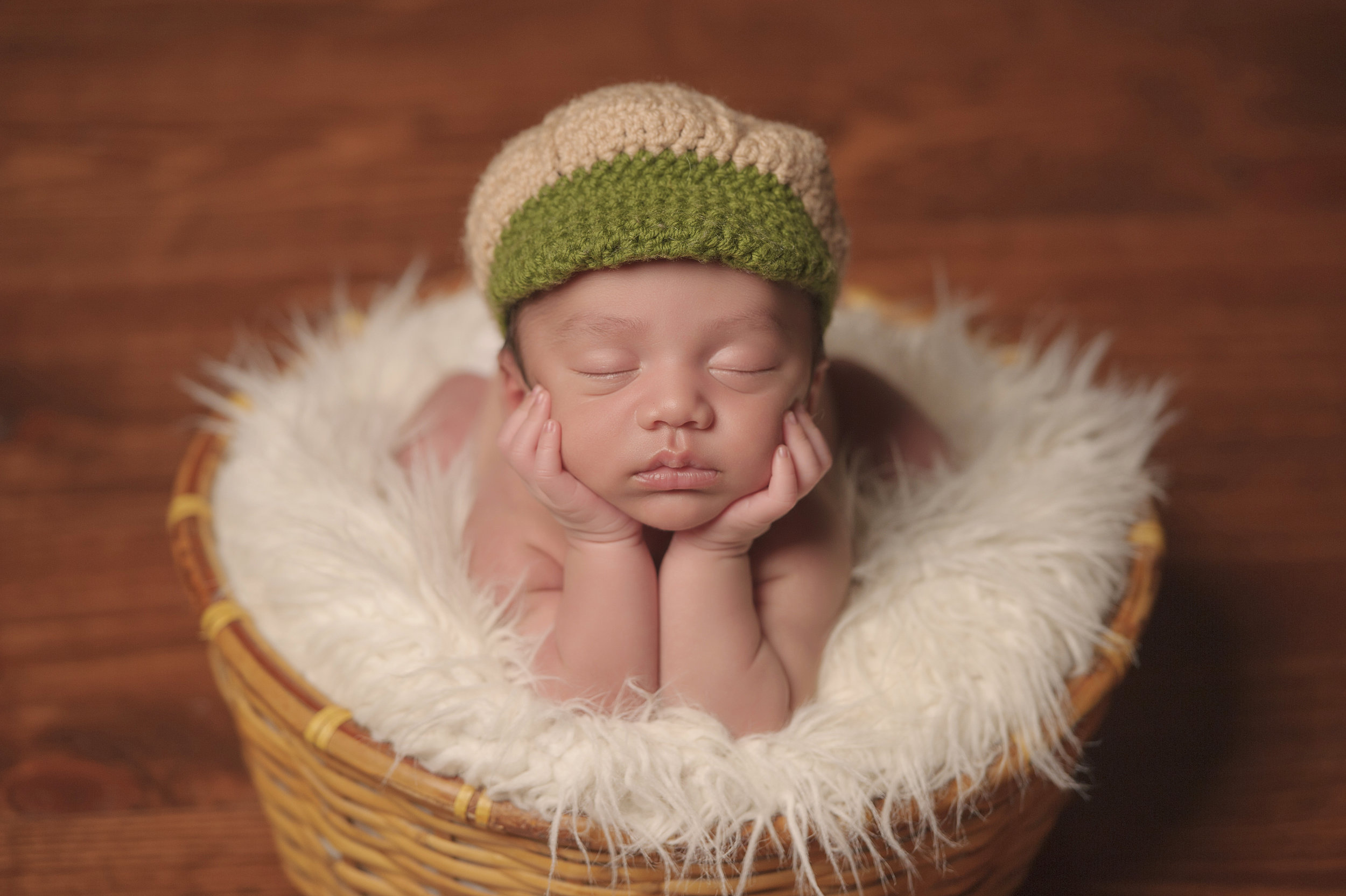 Newborn baby posed in an adorable sleeping position