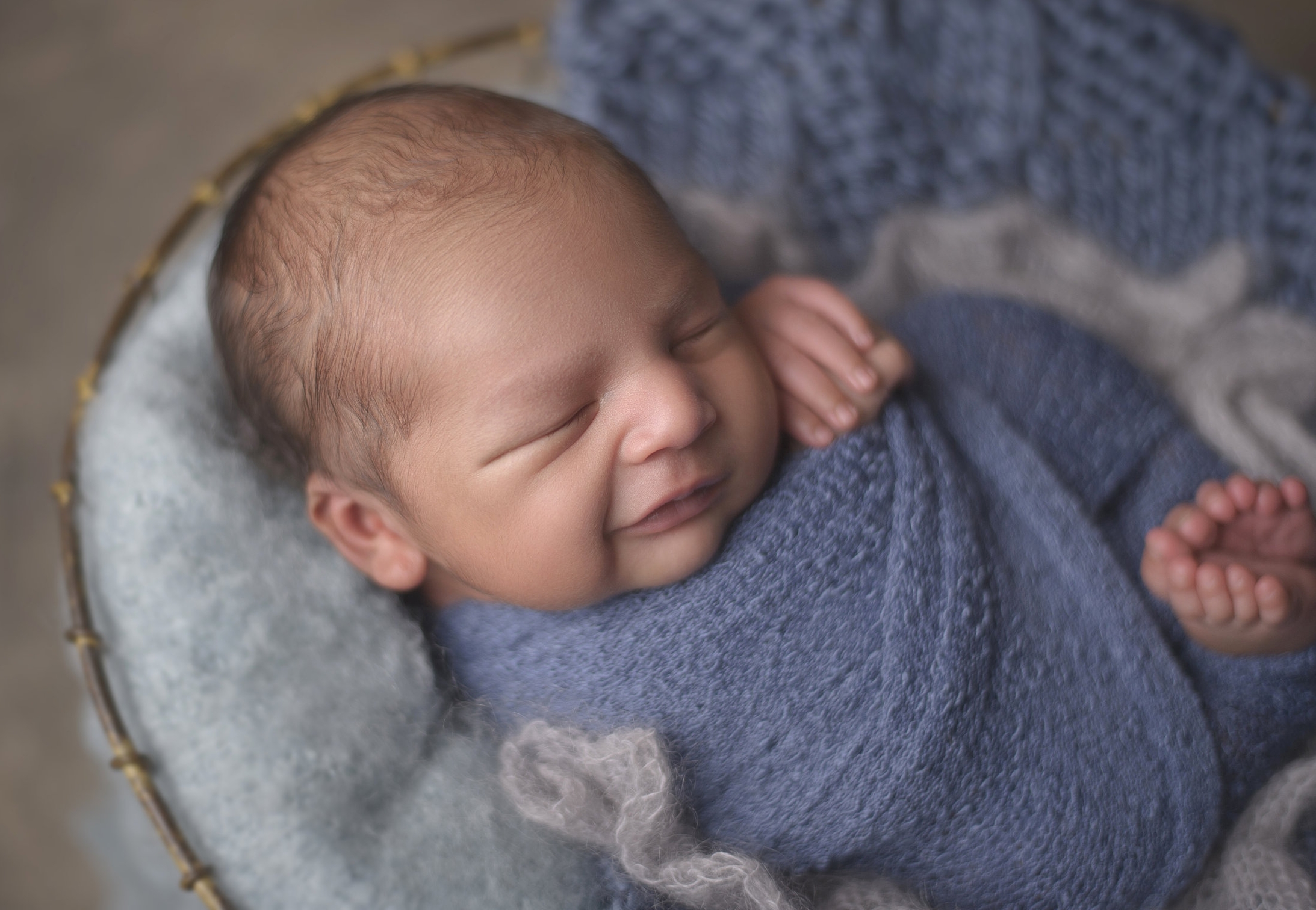 Newborn baby wrapped in a personalized blanket