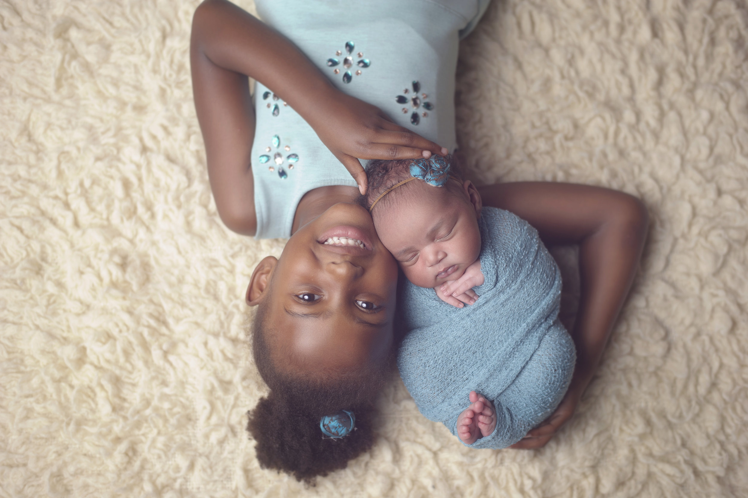 Newborn baby cradled in loving arms