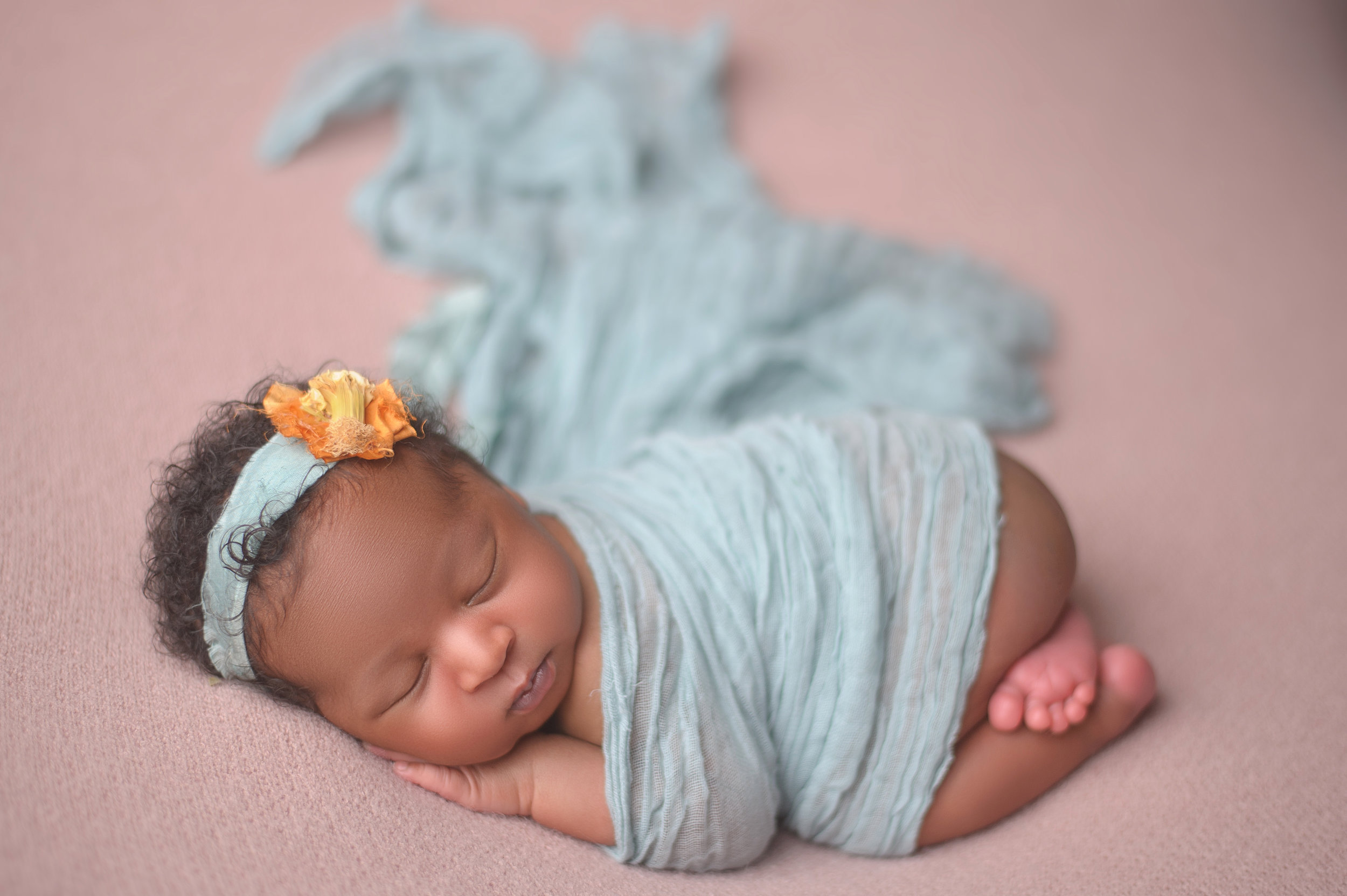 Newborn baby adorned with floral headband