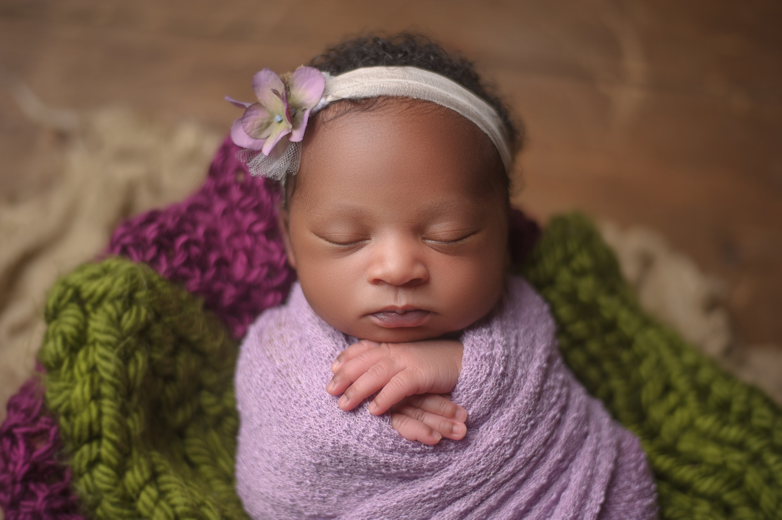 Newborn baby adorned with floral headband