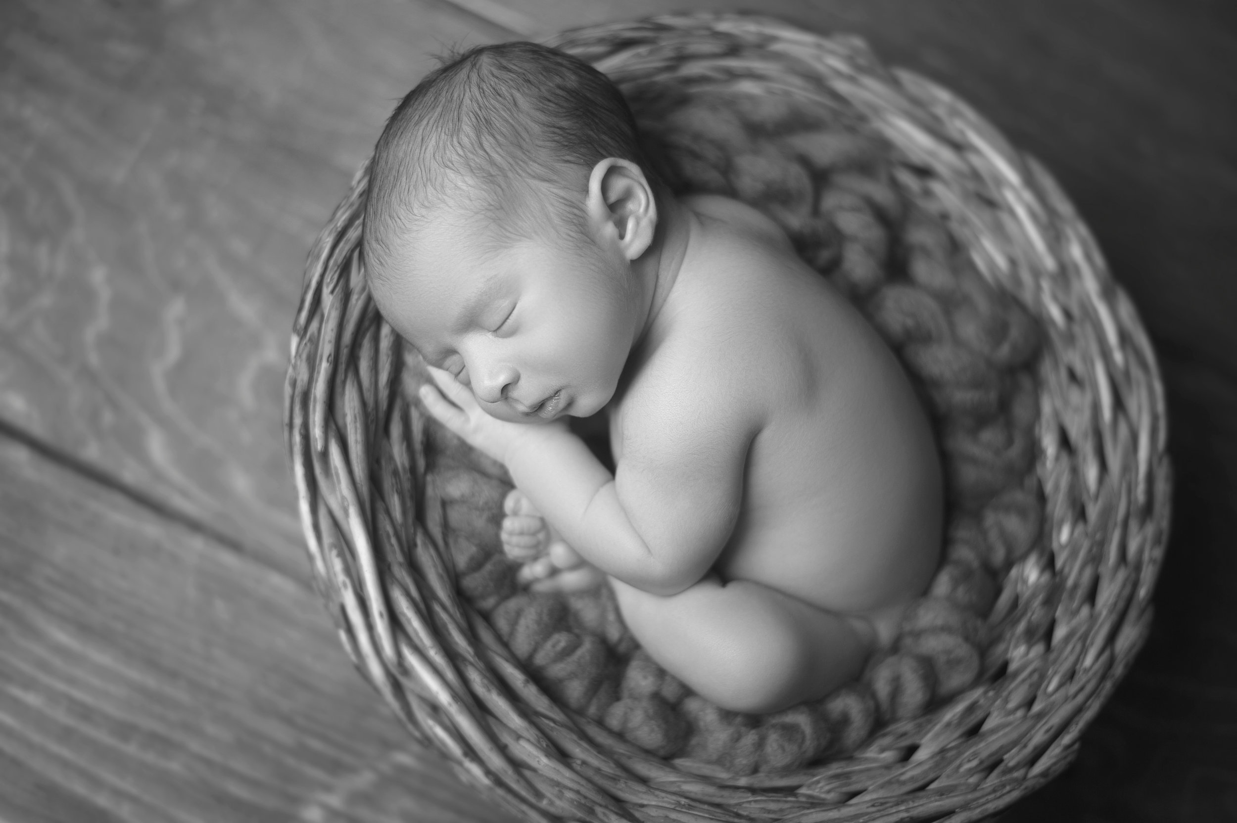 Newborn baby sleeping in a basket