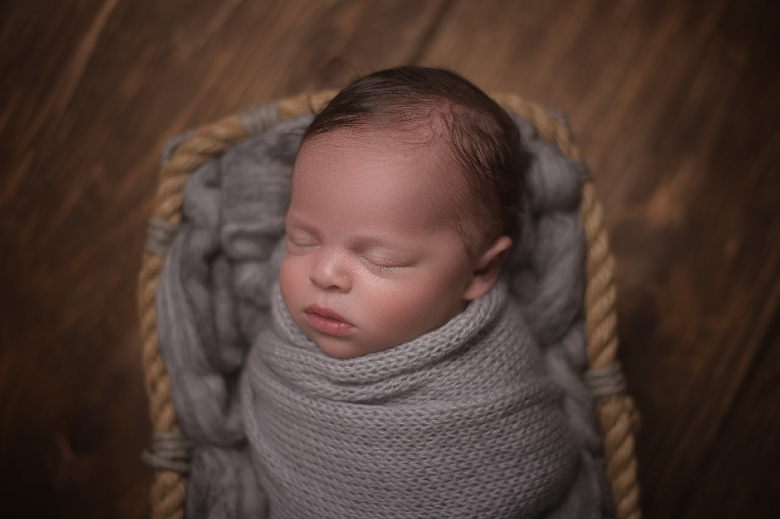 Newborn baby sleeping in a basket