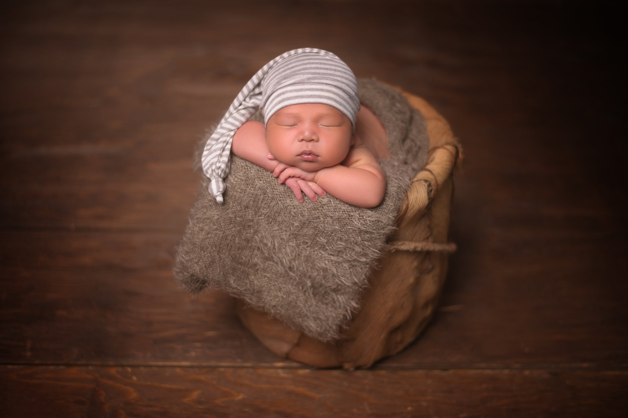 Newborn baby sleeping in a basket