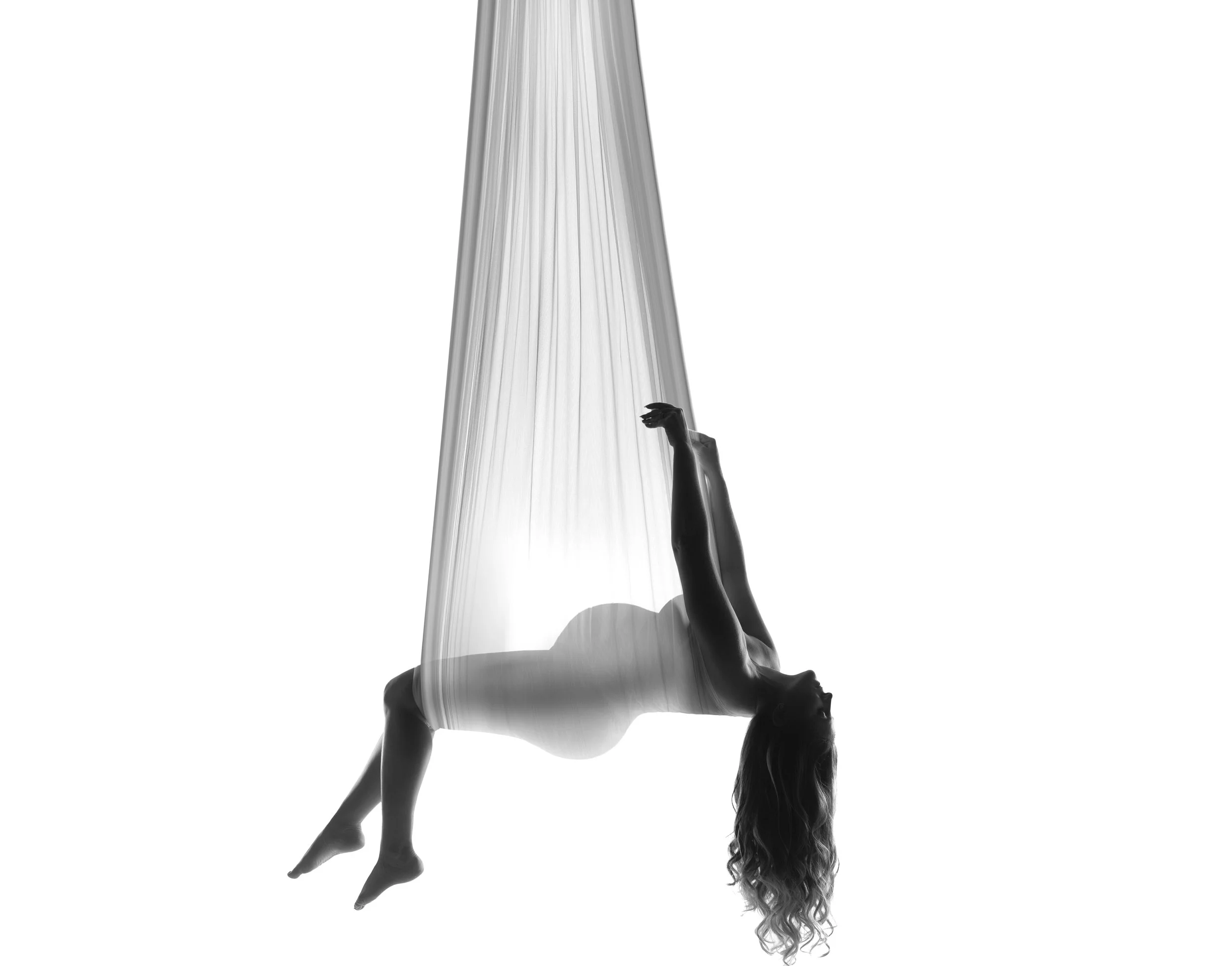 Dramatic Maternity Photography in Chicago. Aerial silk maternity silhouette by Chicago pregnancy photographer Sri.