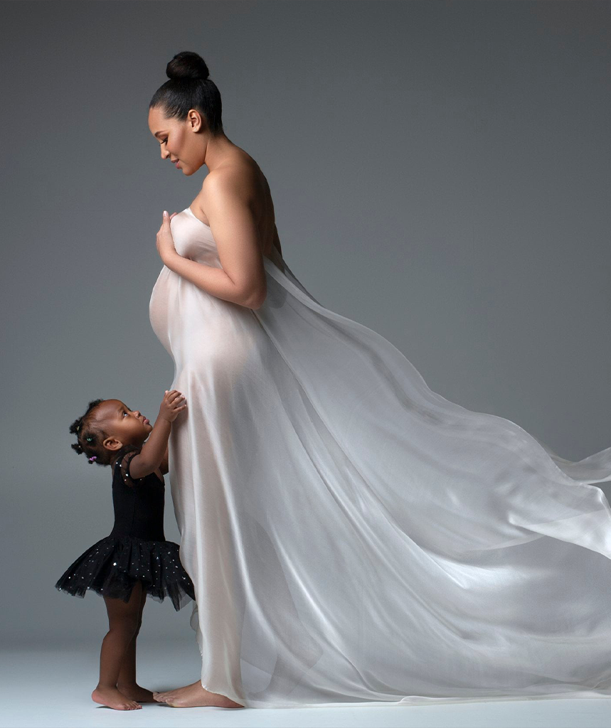 Chicago pregnant mother looking at her 24 month daughter