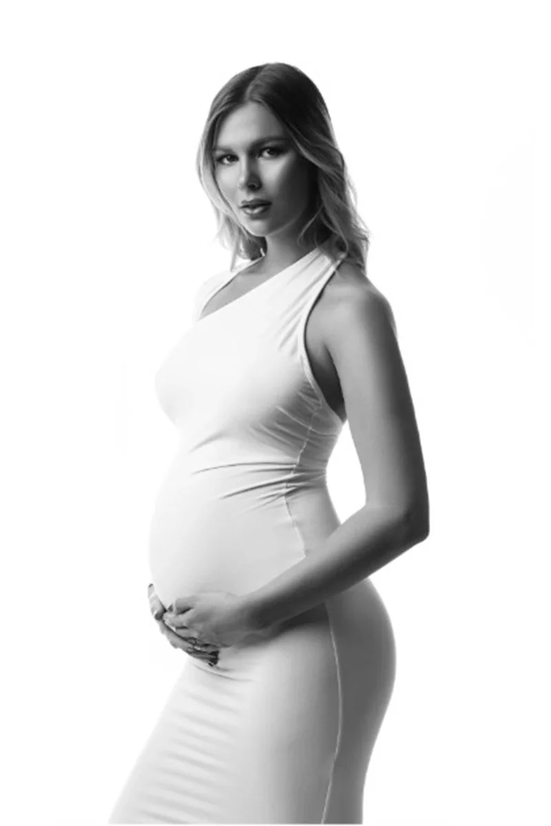 Chicago pregnant woman in a form-fitting white dress