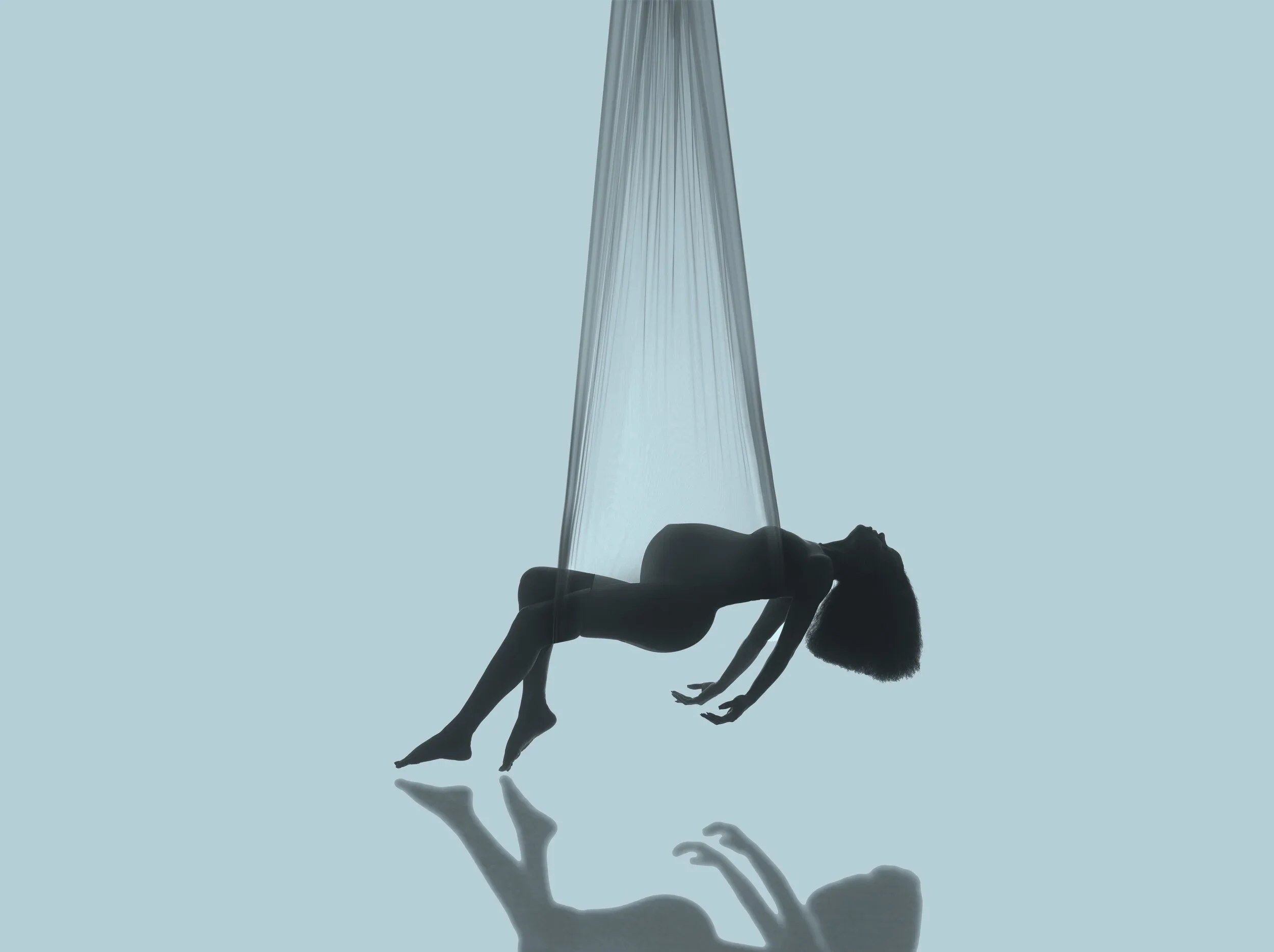 The image shows a person holding a flowing fabric or curtain against a pale blue background. The person's body is mostly obscured, but their hand and arm are visible at the bottom of the image.