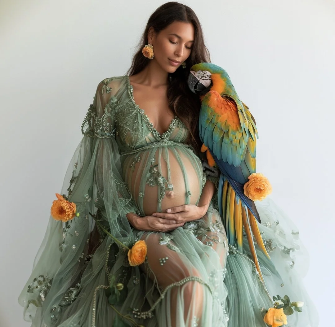 Artistic maternity portrait. Pregnant woman in a sheer green embroidered dress with a vibrant colorful macaw parrot.