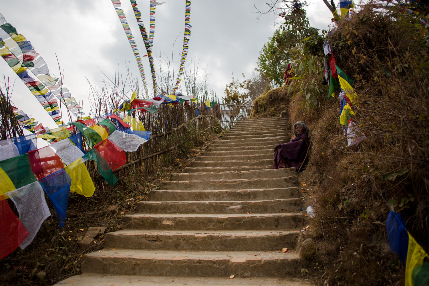 Woman-sitting-on-stairs-at-temple-in-nepal.jpg