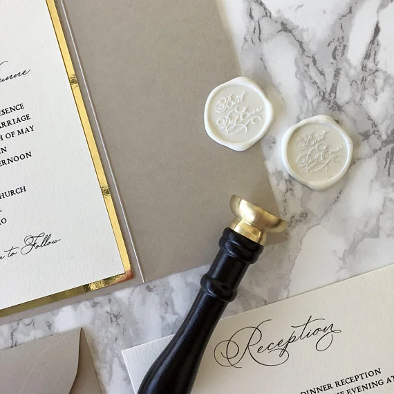 neutral toned wedding invitation with wax seal