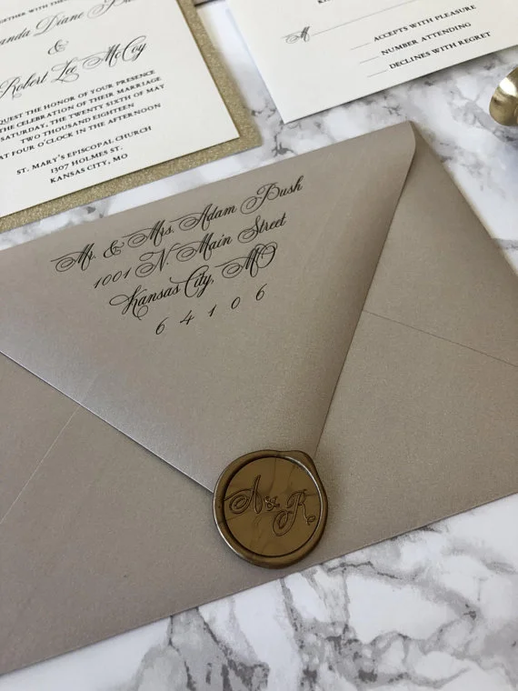 neutral metallic wedding invitation with wax seal