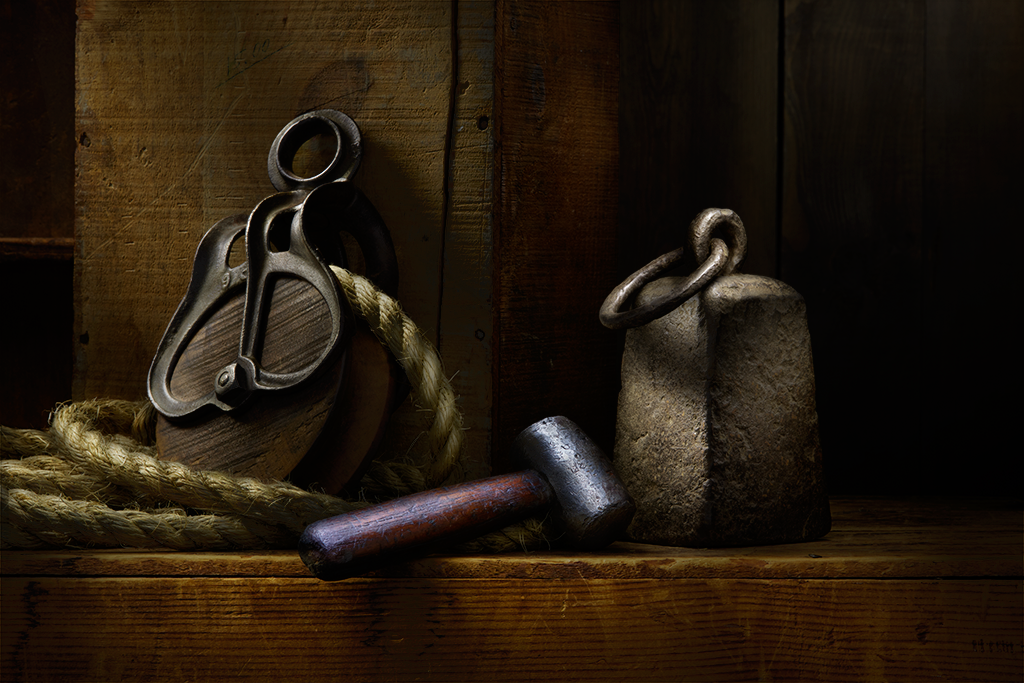 Still life of rope, pulley, and anvil.