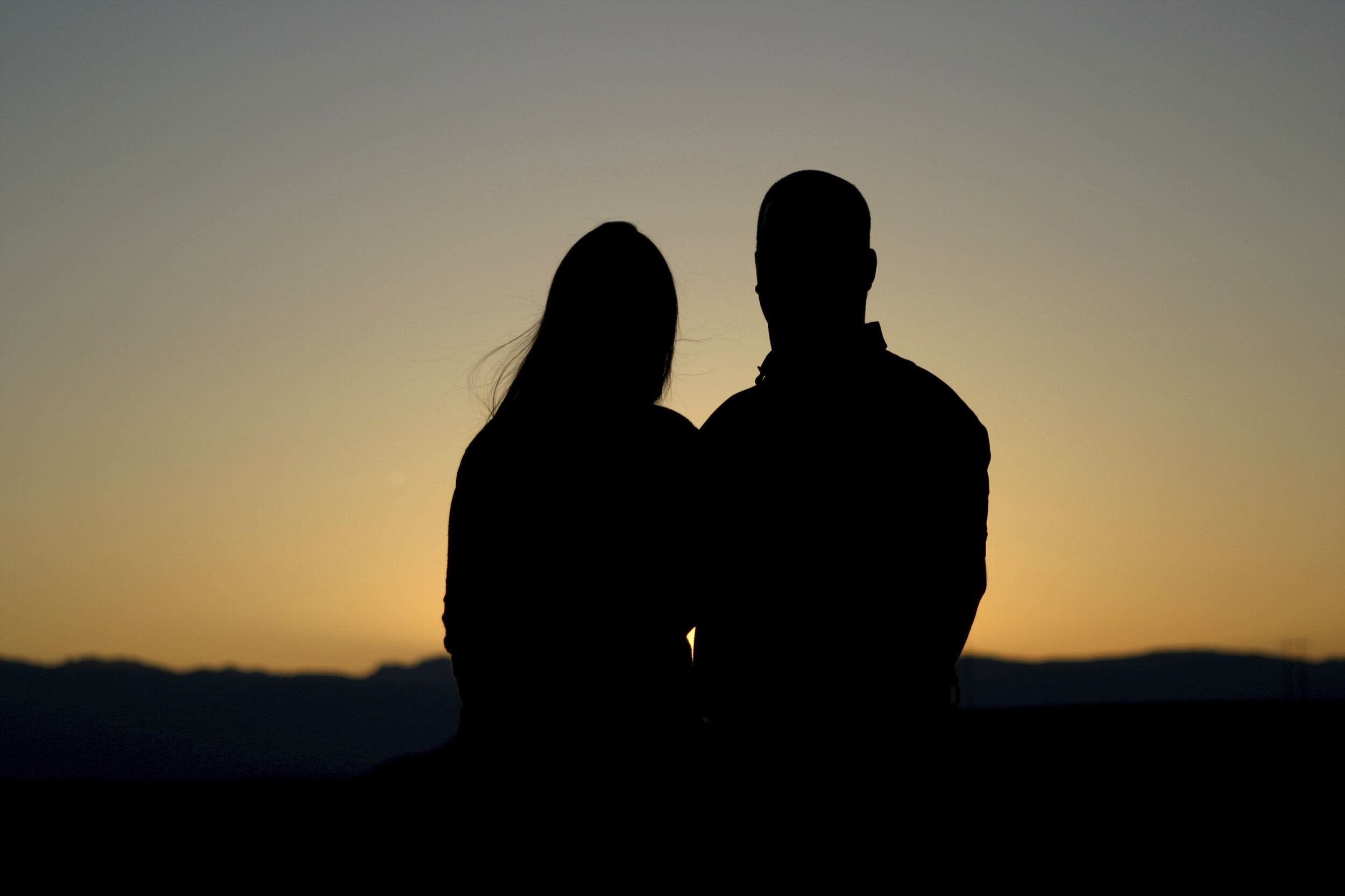 Silhouette of a couple in front of a sunset