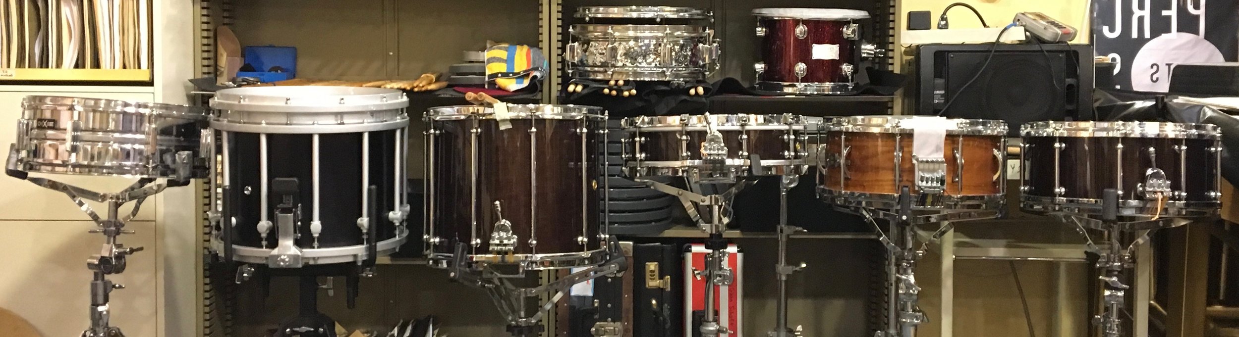 Snare Drum Alley (L to R): Dixie Steel Snare fitted w. Remo Silent One practice head, Yamaha SfZ 14" Marching Snare, Pearl Philharmonic 14x12" Field Drum, Pearl Philharmonic 14x4" maple Piccolo Snare, Black Swamp Percussion/John Craviatto solid walnut 14x6.5 concert drum, and Pearl Philharmonic 14x6.5" maple shell.