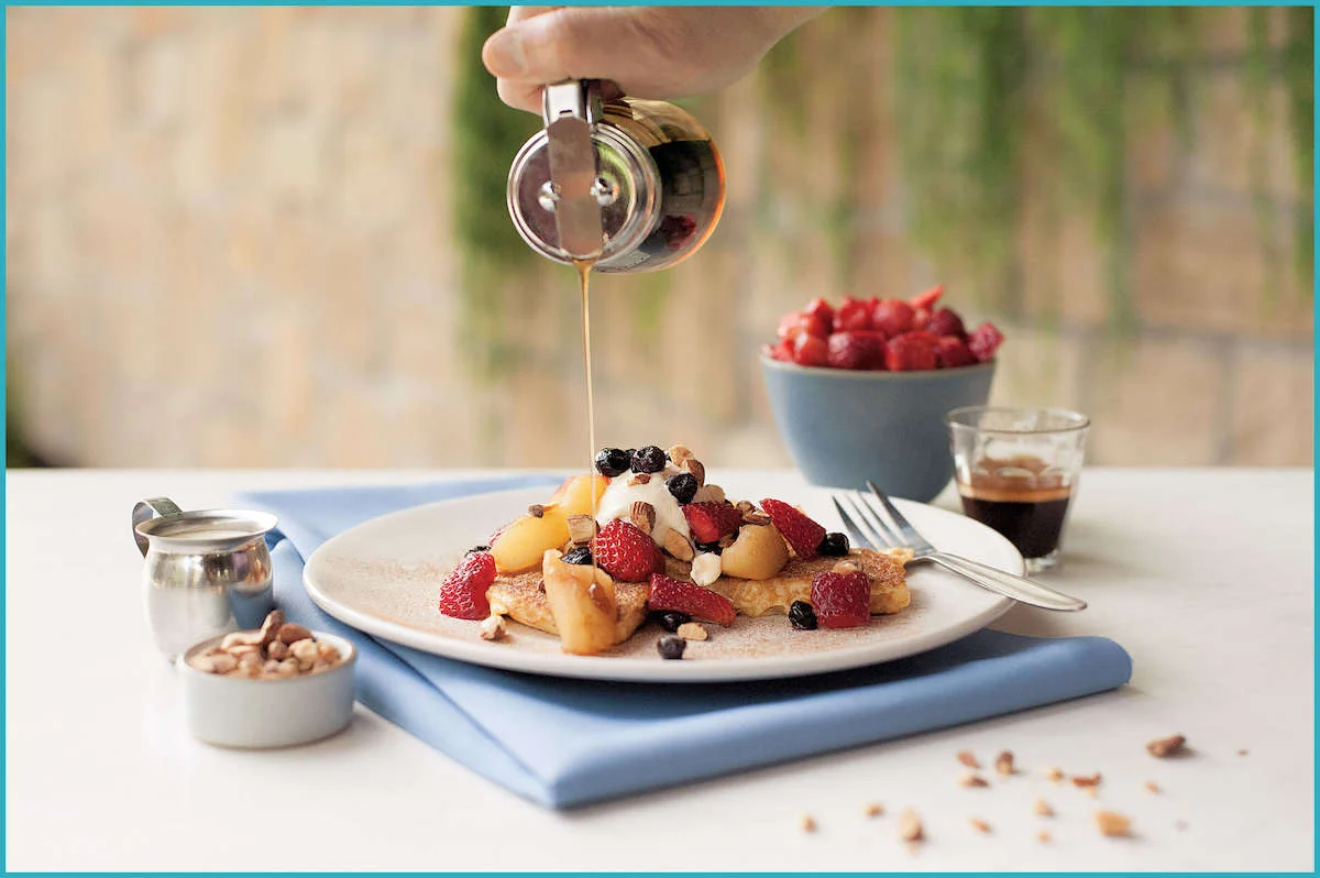 A French toast-style pancake topped with Greek yoghurt, berries, spiced apple and crushed almonds.