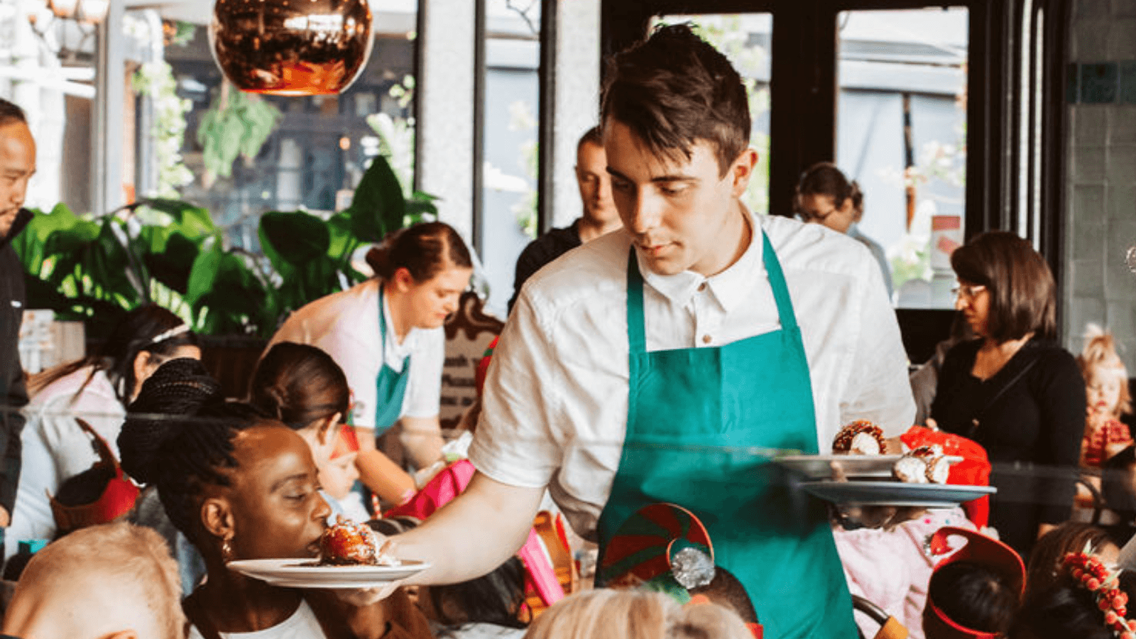 The Pancake Parlour team member serving customers at a busy restaurant