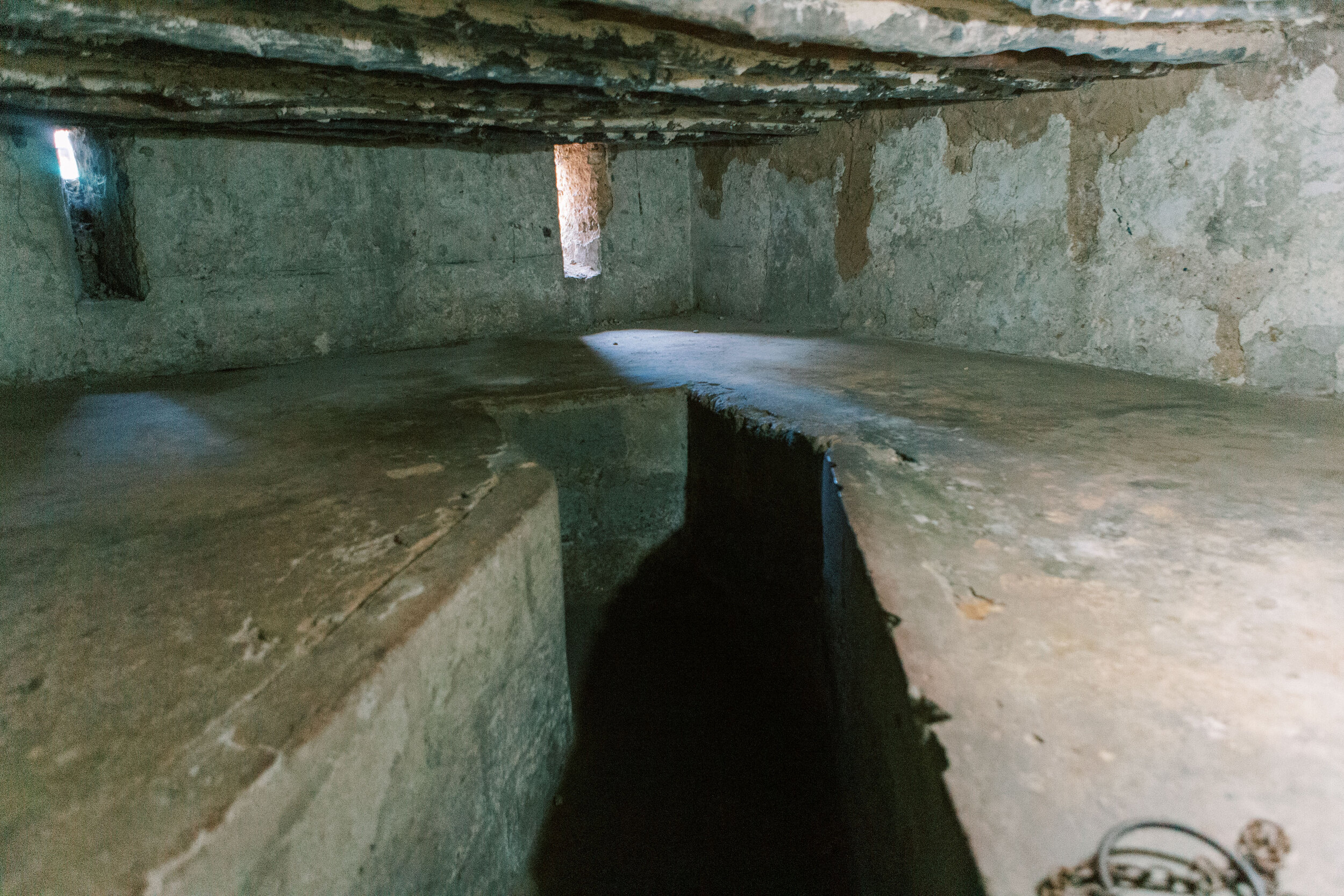  Inside the dark slave chamber, where more than 65 people would be crowded into the space to await auction at the slave market above. 