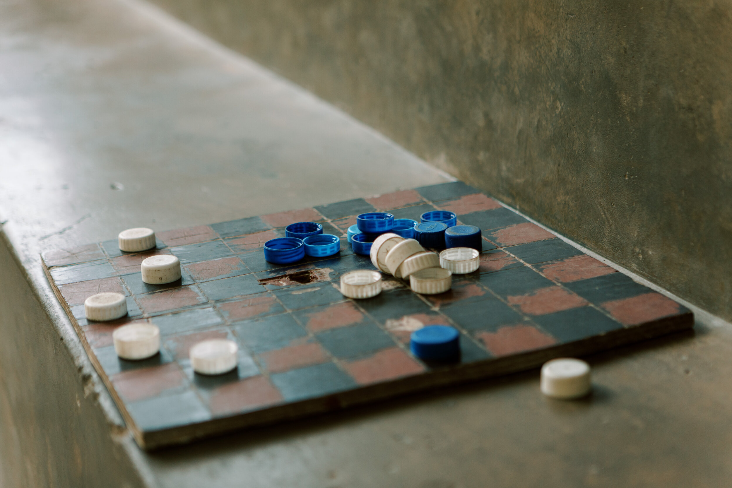  A checkerboard awaits game players inside the museum with bottle caps used as game pieces. 