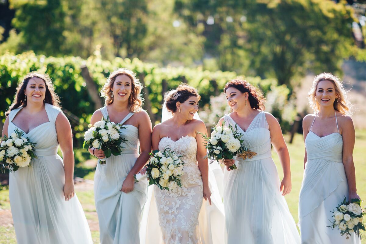 The bridesmaids are wearing Amsale gowns in the colour Ice