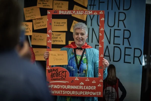 A participant finds her super power and puts on the super hero cape.
