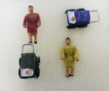  2 WOMEN W/BABIES IN BABY CARRIAGES