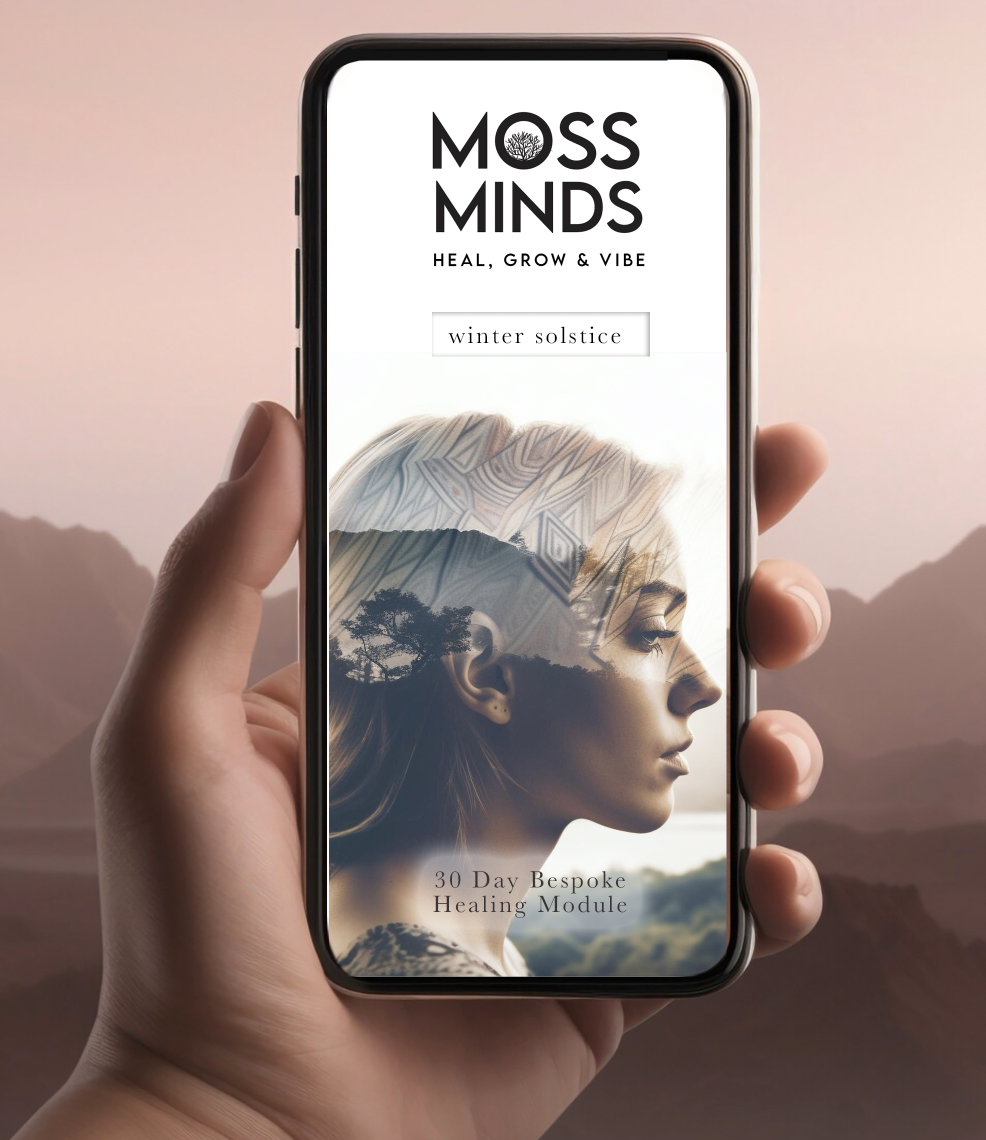 A smartphone displaying a wellness app called MOSS MINDS with a profile of a woman’s face and mountains in the background.