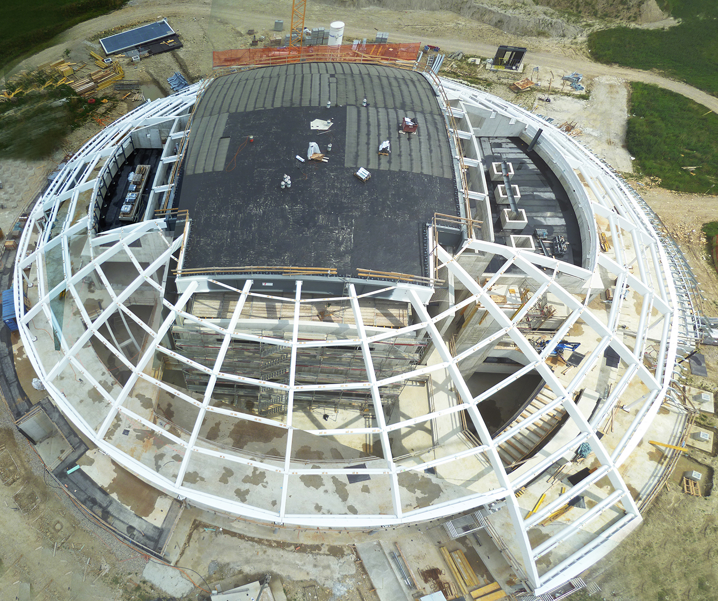 Construction photo showing the steel framing members, upper-level terraces, and roof of the concert hall.