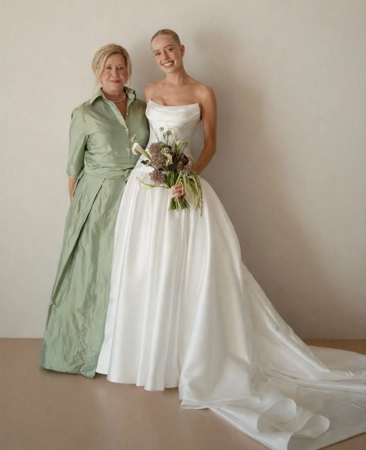 mother of the bride @janice.schuppert.7 looking gorgeous in soft green alongside beautiful bride @jamieschuppert on her wedding day. #LucianaEmilia