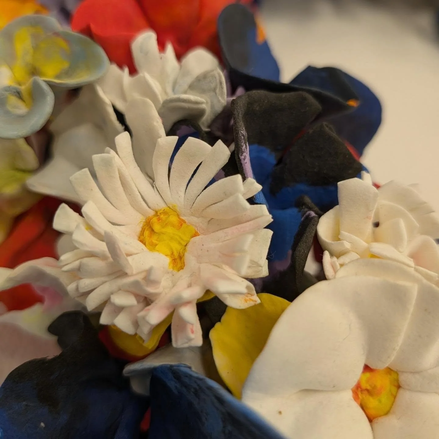 REPOST &bull; @polygonartspace Details of works that are part of Island Welcome, an exhibition about the plight of asylum seekers through the lens of contemporary jewellery 

1. @ordinari_observer made a garland of paper clay flowers that reference t