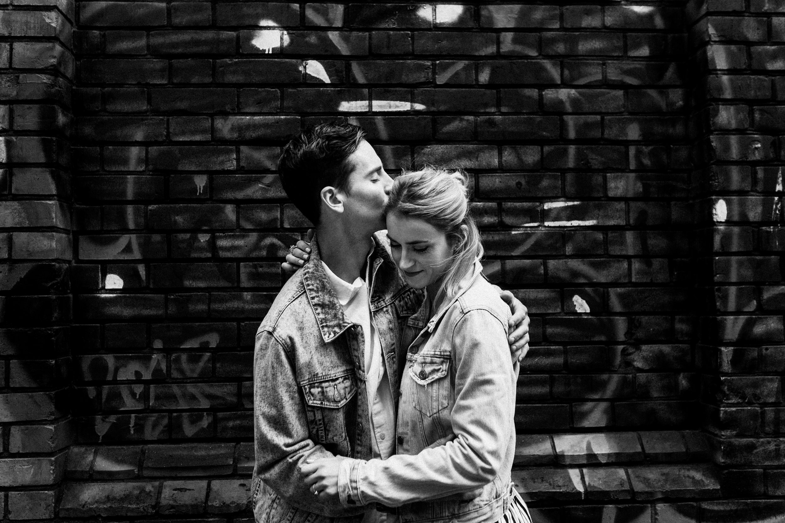 Couple embrace during their pre-wedding photoshoot in Brick Lane.